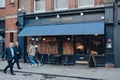 Facade of Chicks and Sours restaurant in Covent Garden, London, UK, people walking past, motion blur