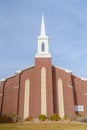 Facade of church with brick wall and white steeple