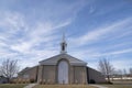 Facade of a church in a low angle view with a sky and clouds background