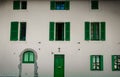 Facade of a church in the old town of Cannes city with green wooden door and windows Royalty Free Stock Photo