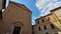 facade of a church and small square of an ancient italian medioeval village