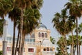 Facade of Ciutat Jardi hotel with a round roof surrounded by tall palm trees Royalty Free Stock Photo