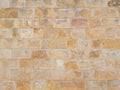 Travertine masonry texture. Facade cladding. Wall with orange rough masonry. Full screen photo. Not seamless texture Royalty Free Stock Photo
