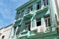 Facade of colonial residential building in old Havana. local man on balcony. Linen, drying on rope