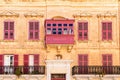 Facade with colorful balcony and shutters, Mdina, Malta