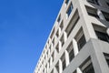 Facade of a concrete office building with glass windows. Wide low angle photo of multistory building. Windows. Urban real estate