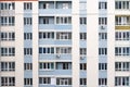 Facade of condominium. Multi-storey residential building. Abstract texture. Wall with windows and balconies of Russian and Ukraini Royalty Free Stock Photo