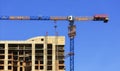 Facade and construction crane near the modern concrete building under construction Royalty Free Stock Photo