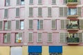 Facade of constructivist house with windows in the style of the seventies with pink panels and balconies