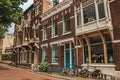 Facade of elegant brick buildings and bicycles on the street in a cloudy day at Dordrecht. Royalty Free Stock Photo