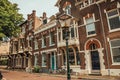 Facade of elegant brick buildings and bicycles on the street in a cloudy day at Dordrecht. Royalty Free Stock Photo