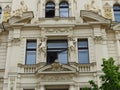 Facade of an elegant building with statues of Prague in Czech Republic.