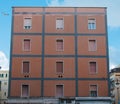 facade of european building with shuttered windows under blue sky,
