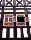 Facade of an ancient fachwerk house with stained glass windows, Erfurt, Germany