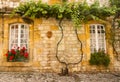 Facade with flowers Monpazier Royalty Free Stock Photo