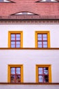 Facade with four orange framed windows Royalty Free Stock Photo
