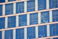 Modern office building facade abstract fragment, shiny windows in steel structure.