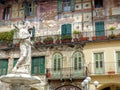 Facade with frescoes with the statue of the Madonna of Verona in Italy. 