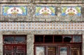 Facade of old, decayed house with beautiful tile pattern