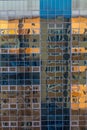 Facade of a glass wall of a modern building with reflection of another building Royalty Free Stock Photo