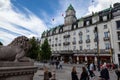 Facade of the Grand Hotel Oslo historical building with a statue of lion in front, Norway