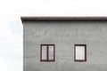 Facade of a gray house with red windows Royalty Free Stock Photo