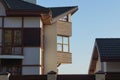 Facade of a gray private house with a brown closed wooden balcony Royalty Free Stock Photo