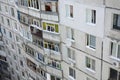 Facade of a grey multi storey soviet panel building. Russian old urban residential houses with windows and balcony. Russian Royalty Free Stock Photo