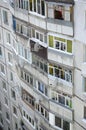 Facade of a grey multi storey soviet panel building. Russian old urban residential houses with windows and balcony. Russian Royalty Free Stock Photo