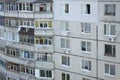 Facade of a grey multi storey soviet panel building. Russian old urban residential houses with windows and balcony. Russian Royalty Free Stock Photo