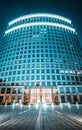 Facade of high business center building with bright neon blue lights, Irvine, USA, low angle