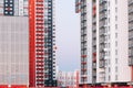 The facade of a high-rise building with red white and gray stripes. Multi-storey building against the blue sky. Background to Royalty Free Stock Photo