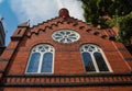 Facade of a historic church with round windows on a brick wall. Victoria BC, Canada. July 23,2021 Royalty Free Stock Photo