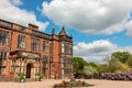 Facade of an historic English mansion in red brick.