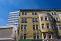 The facade of a historic tenement house and a fragment of a modern office building in the city of Poznan