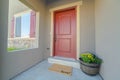 Facade of home with red front door and wooden shutters on the sliding window Royalty Free Stock Photo