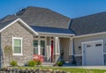 Facade of a home with stone brick wall and small porch against blue sky Royalty Free Stock Photo