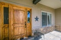 Facade of home with wooden door and sunlit porch