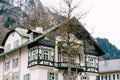 Facade of a house in the background of mountains in the village of Oberammergau, Germany