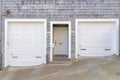 Facade of a house on a concrete slope with two white garage doors at San Francisco, California Royalty Free Stock Photo