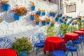 Facade of house with flowers in blue pots in Mijas. Malaga prov Royalty Free Stock Photo