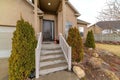 Facade of house with stairs bench on the portico and front door with sidelight Royalty Free Stock Photo