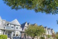 Facade of houses in San Francisco, California with street lights and trees at the front Royalty Free Stock Photo