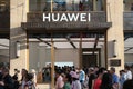 Facade of HUAWEI flagship store with crowd of people