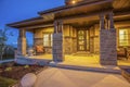 Facade of an illuminated home against mountain and sky at twilight