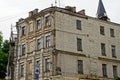 Facade of a large brown old brick house with a row of windows Royalty Free Stock Photo