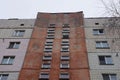 Facade of a large brown panel house with rows of windows