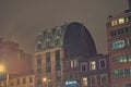 he facade of the Le Dome hotel building and the facades of other buildings. Street landscape of a large city at night Royalty Free Stock Photo