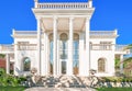 The facade of a luxurious residence with columns in the Corinthian style, with large windows. Luxury house in a classic style. Be