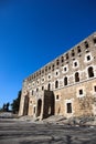 Facade of majestic and well preserved Roman theatre in ancient city Aspendos, Turkey under blue spring sky